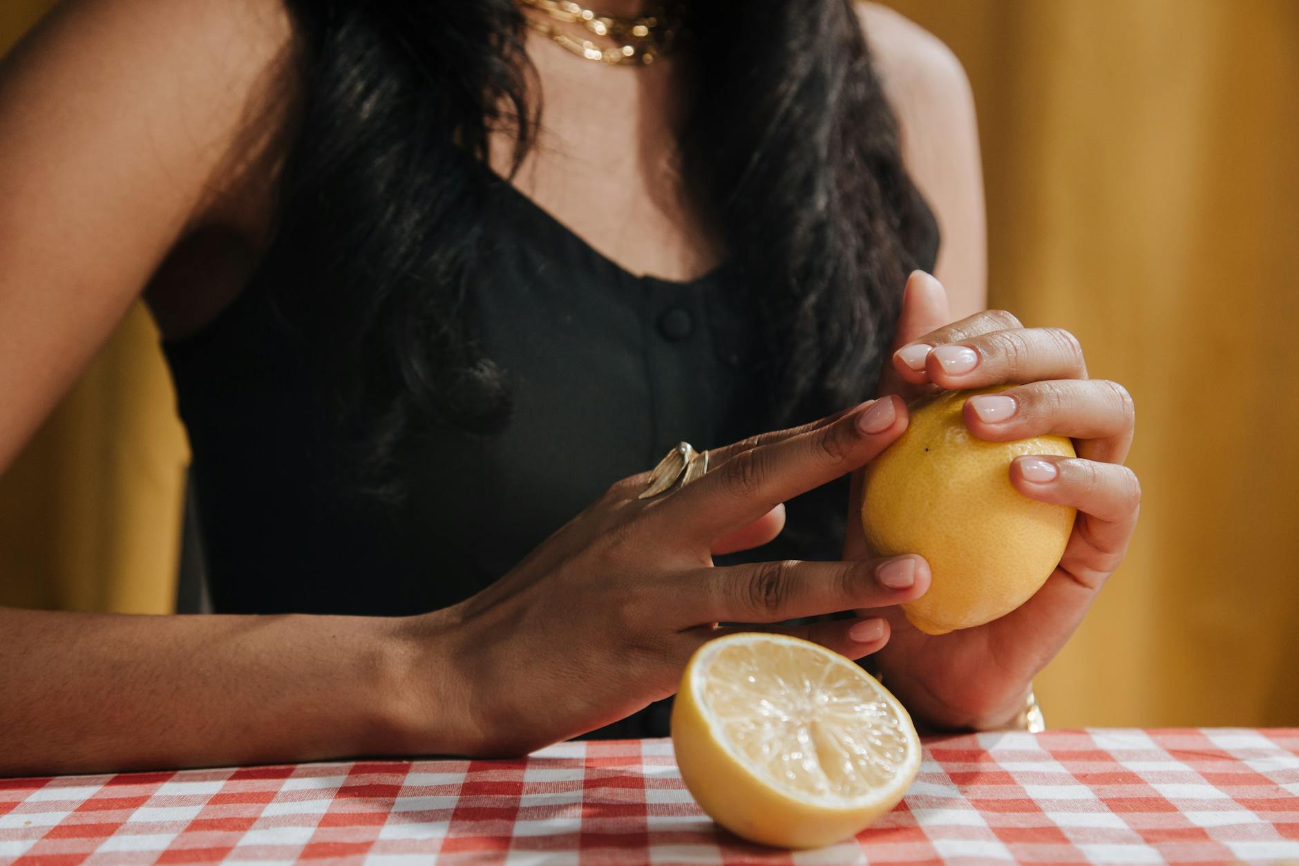 Close-up of hands gently holding a sleek blue vibrator against a purple background