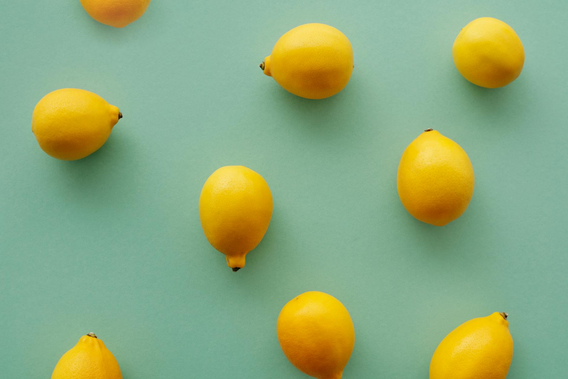 Bright yellow lemons arranged on a soft pastel background, symbolizing fresh reconnection and intimacy