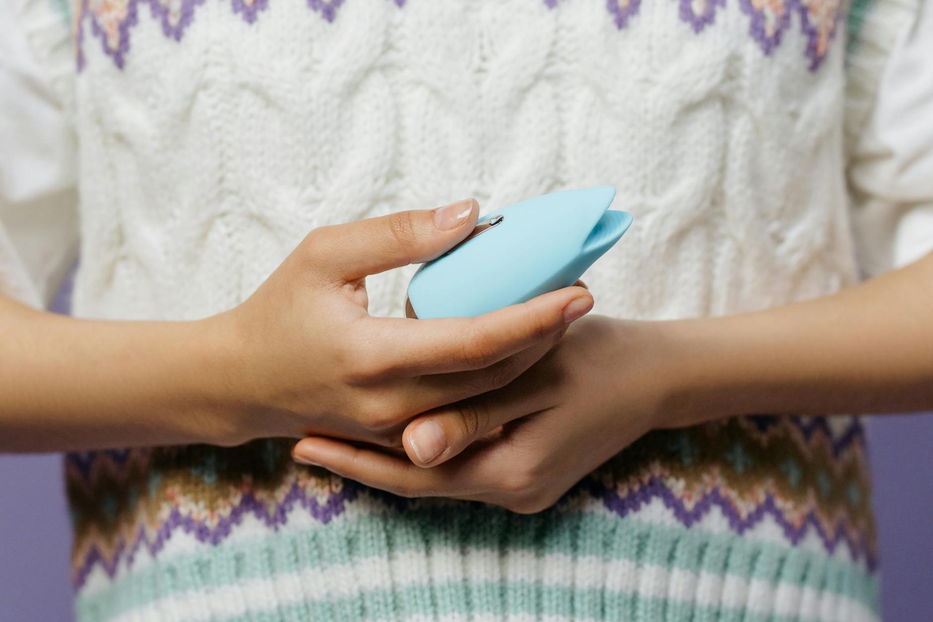 Hands holding a lemon vibrator, showing comfort and control over your own pleasure