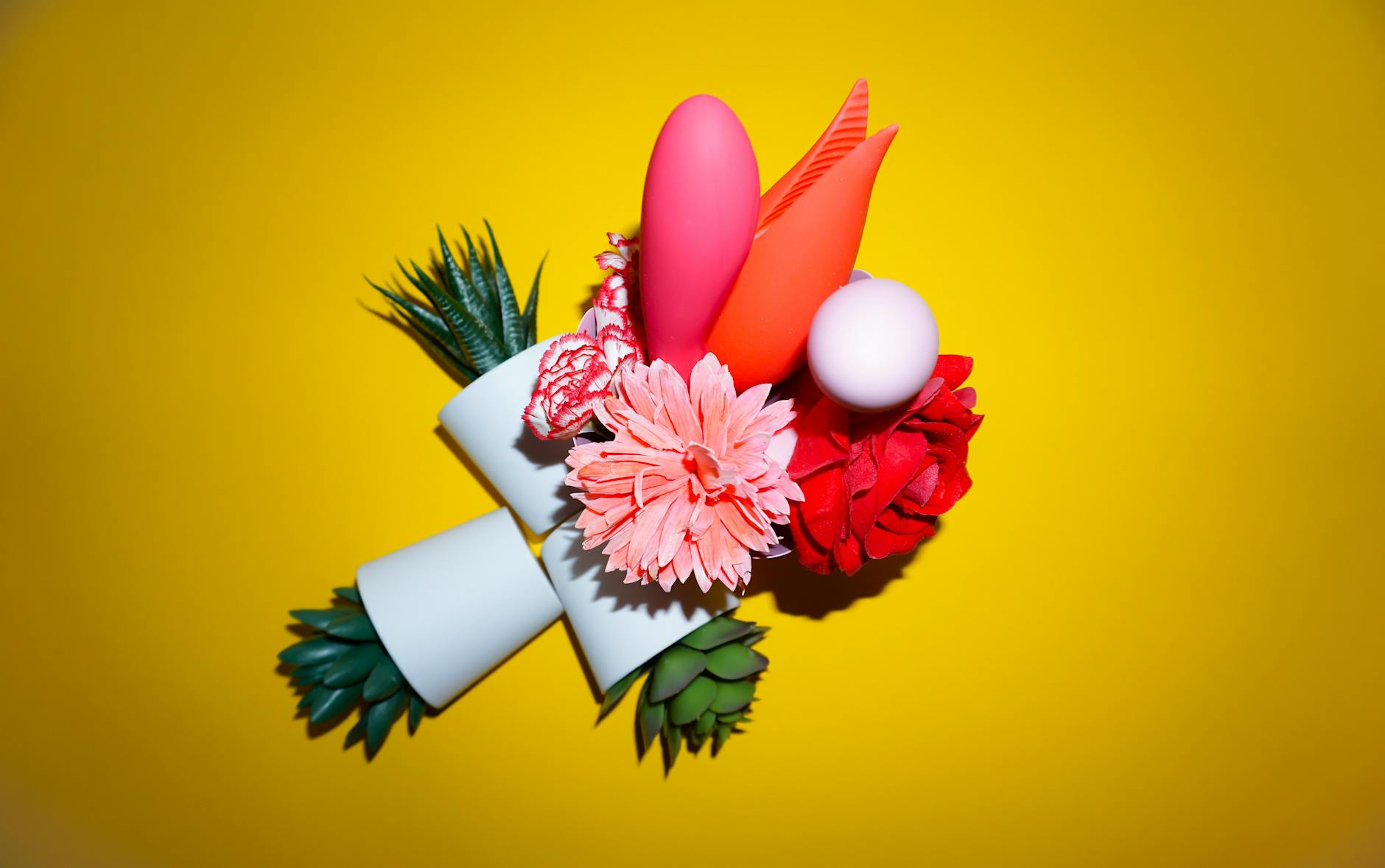 Colorful arrangement of flowers and abstract objects on a bright yellow background symbolizing renewal and reconnection