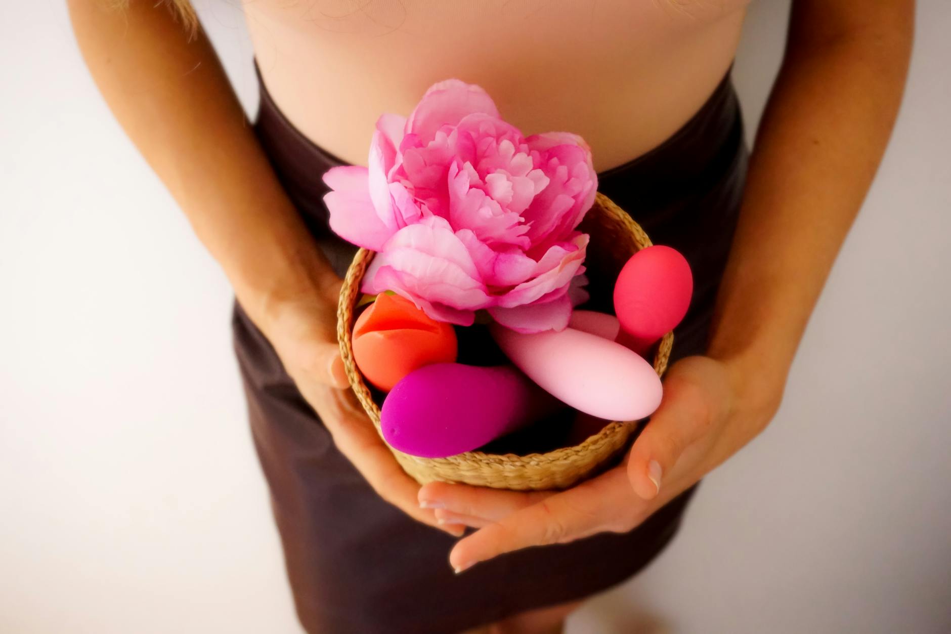 Vibrant arrangement of colorful sex toys displayed on a bright yellow surface