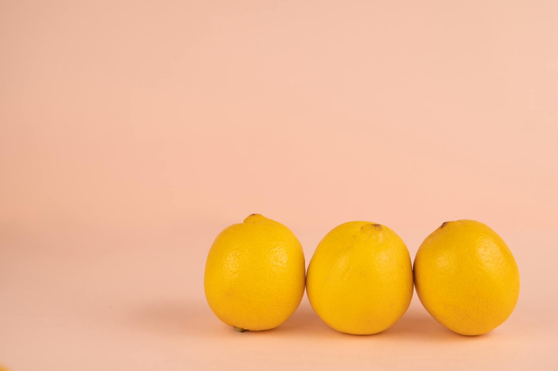Bright ripe lemons arranged on a pastel background, symbolizing sensitivity and natural pleasure