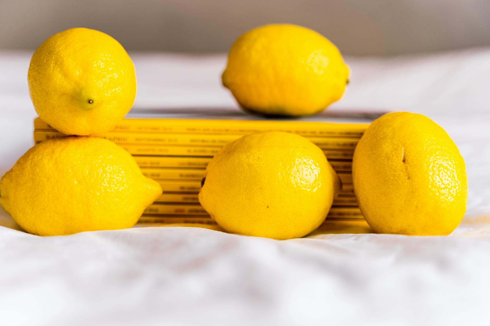 Colorful lemon adult toys arranged on a bright yellow background, representing fresh starts and pleasure rediscovery